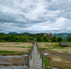 Aerial view Amazing beauty in the hill tribe village.The bridge snaking through the rice fields to link the clergy and the community is one of Mae Hong Son's longest and most beautiful bamboo bridges