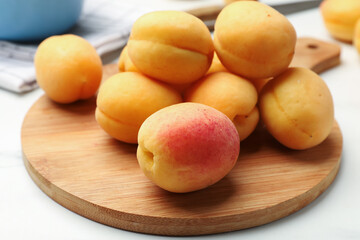 Fresh ripe apricots on white table, closeup