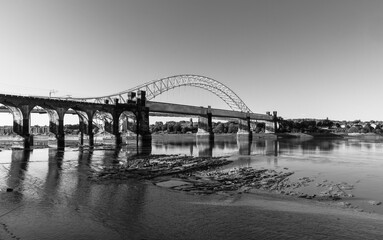 Ethelfleda Railway Bridge and Silver Jubilee Bridge in morning light in black and white