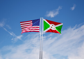 flags of burundi and United States of America over blue sky background.
