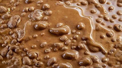 Close-Up Texture of Rich Brown Chocolate Ganache with Air Bubbles, Showing its Smooth and Creamy Consistency