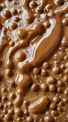 Close-up macro shot of warm, swirling liquid chocolate with a foamy, bubbly texture, creating an abstract and decadent visual delight perfect for food and beverage advertising