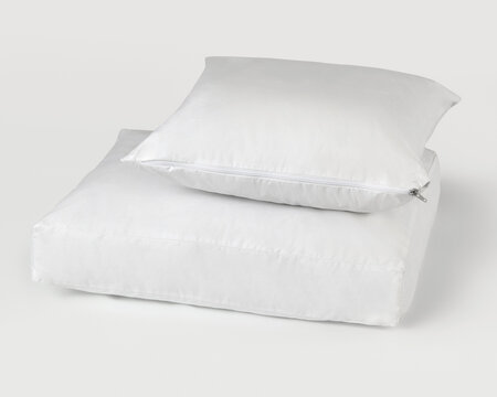 Clean white pillow and mattress protector on white background