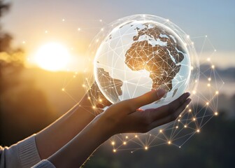 Hands holding a glowing globe with network connections against a bright sunset background view image
