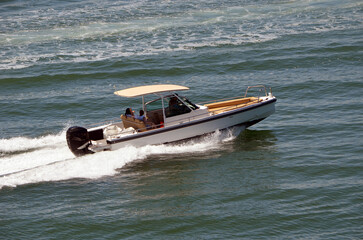 Center Consoled Motor Boat Powered by a Single outboard Engine.