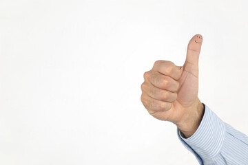 Hand Showing Thumbs Up Gesture with Smiley Face on Thumb
