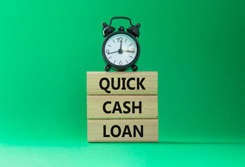 Quick Cash Loan symbol. Concept words Quick Cash Loan on wooden blocks. Beautiful green background...