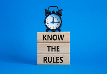 Know the rules symbol. Wooden blocks with words Know the rules. Beautiful blue background with...