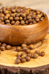 slicing ripe zucchini on a black cooking table, side view with a sharp knife for slicing