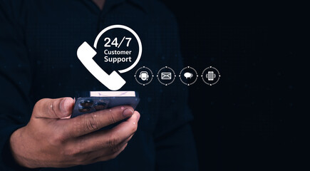A hand holding a smartphone displays icons for 24/7 customer support, highlighting various communication methods like calls and messages.