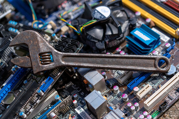 A metal wrench on the background of electronic components.Electronics repair.