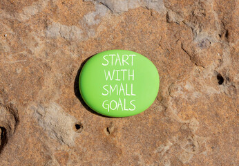 Start with small goals symbol. Concept words phrase Start with small goals on beautiful green...
