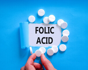Folic acid symbol. Concept words Folic acid on beautiful white paper. White pills tablets....