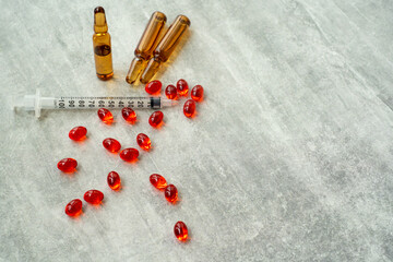 Red ampoules with vitamins on the table.Medicines with additives.