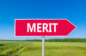 Merit symbol. Concept word Merit on beautiful red road sign. Beautiful blue sky green grass and...