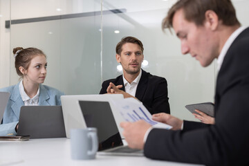 Colleagues collaborating on a project in a modern office