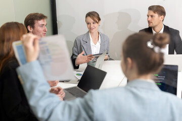 Colleagues collaborating on a project in a modern office