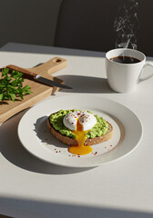 A poached egg with a runny yolk on avocado toast, served with a steaming cup of coffee.
