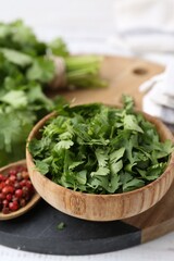 Fresh green cilantro and peppercorns on table, closeup