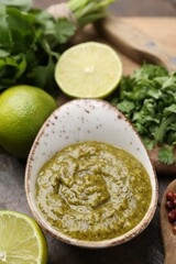 Tasty sauce with cilantro and other ingredients on table, closeup