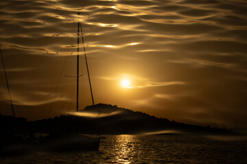 Aesthetic seaport background. Harbour with yachts and boats. Double exposure of the ocean and sunset. Abstract design