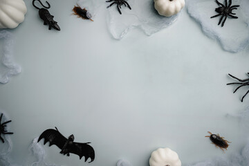 A modern greeting card for Halloween. cobwebs, spiders, bats, a ghost on a fashionable blue...