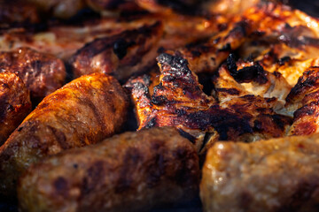 Pork chops, steak, sausages on barbecue grill