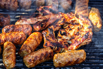 Pork chops, steak, sausages on barbecue grill