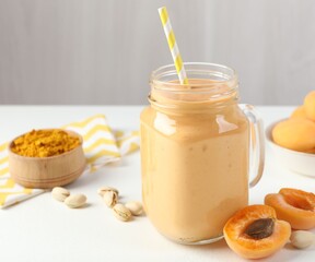 Superfood. Tasty smoothie and ingredients on white table, closeup