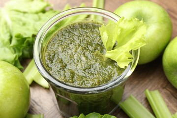 Superfood. Tasty smoothie in glass and ingredients on wooden table, closeup
