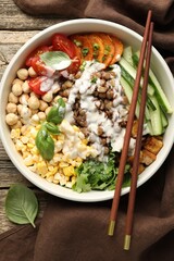Healthy vegetarian food. Delicious Buddha bowl served on wooden table, top view