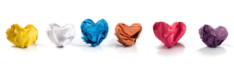 Colorful crumpled hearts representing emotions in a playful arrangement on a transparent backdrop