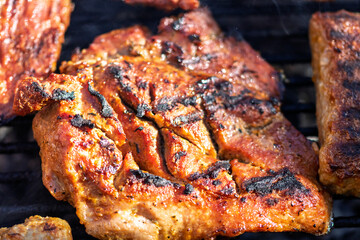 Pork chops, steak, sausages on barbecue grill