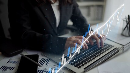 A business professional engaged in data analysis on a laptop surrounded by charts and graphs, representing technology-driven productivity in the modern workplace. Copula