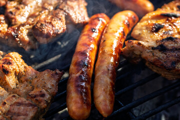 Pork chops, steak, sausages on barbecue grill