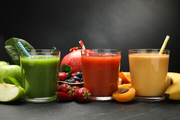 Superfood. Refreshing smoothies in glasses and ingredients on dark textured table, closeup