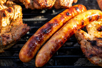 Pork chops, steak, sausages on barbecue grill