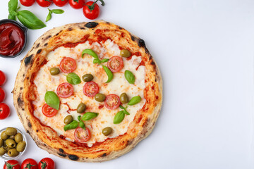 Delicious pizza and ingredients on white table, flat lay. Space for text