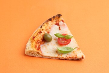 Slice of delicious pizza on orange background, closeup