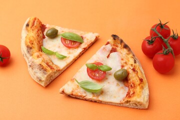 Slices of delicious pizza and tomatoes on orange background, closeup