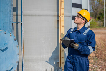 Petrochemical engineer working at petroleum oil refinery industry area. Industrial technician worker maintenance inspect manufacturing energy power gas system at factory.