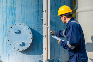 Petrochemical engineer working at petroleum oil refinery industry area. Industrial technician worker maintenance inspect manufacturing energy power gas system at factory.