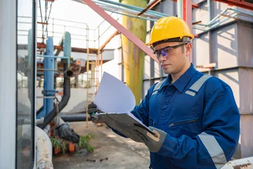 Fotobehang Petrochemical engineer working at petroleum oil refinery industry area. Industrial technician worker maintenance inspect manufacturing energy power gas system at factory. © reewungjunerr