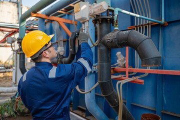 Petrochemical engineer working at petroleum oil refinery industry area. Industrial technician worker maintenance inspect manufacturing energy power gas system at factory.