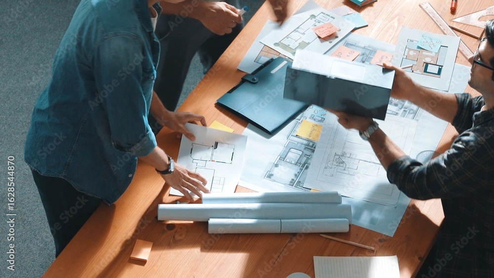 Poster top view of smart civil engineer looking project plan at meeting table while design building constru