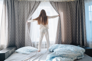 A girl with long hair enjoys a peaceful awakening early in the morning.