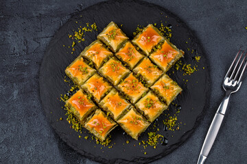 Turkish dessert pistachio baklava on black background. Special mini baklava