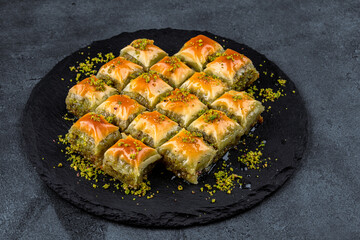Turkish dessert pistachio baklava on black background. Special mini baklava