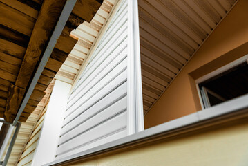 Installation of siding on the walls around the balcony window.