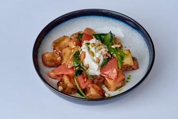 A Deliciously Fresh Salad Featuring Diced Tomatoes, Spinach, Creamy Dressing, and Crunchy Nuts, Perfect for a Healthy and Flavorful Meal Option